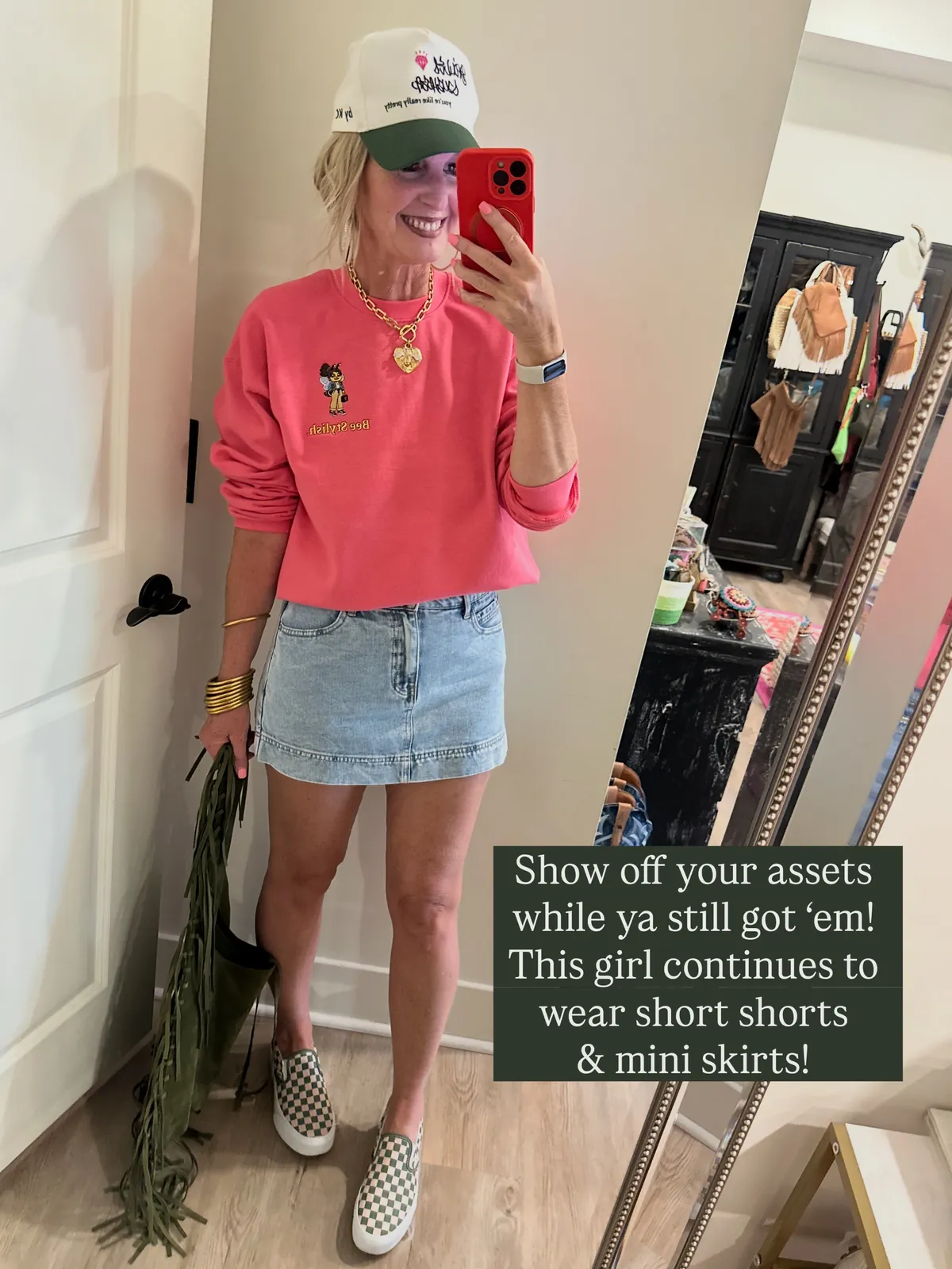 Melanie wearing the Bee Stylish sweatshirt with a denim mini skirt